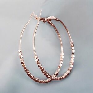 Minimalist medium sized rose gold plated hoop earrings. New.
